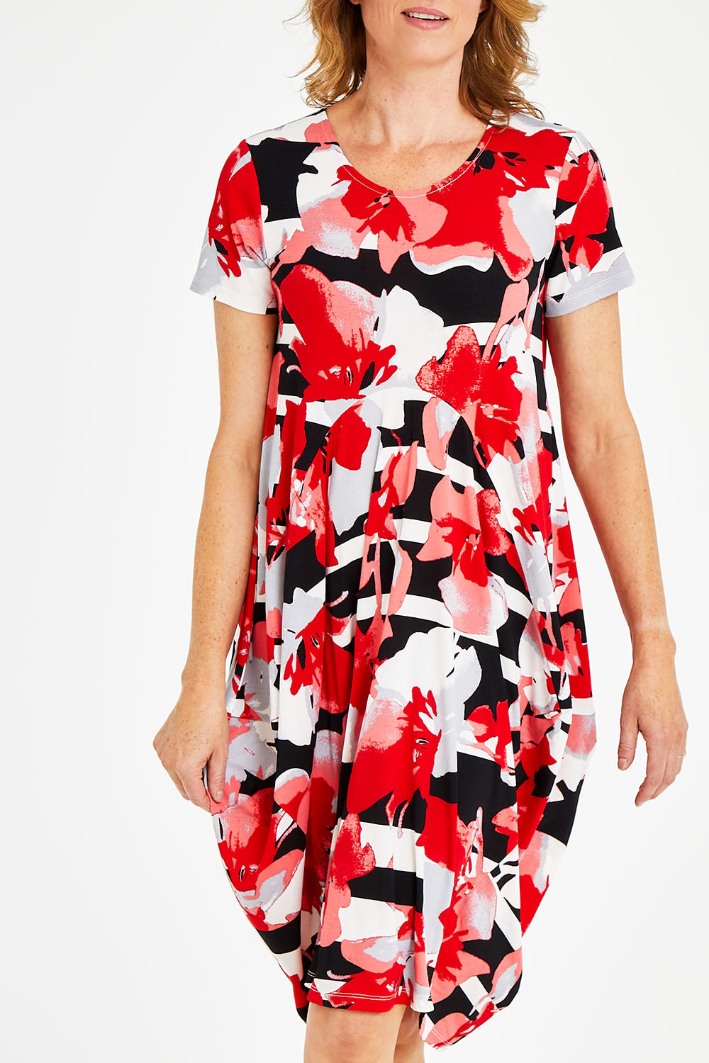 Model Naomi wearing size 10 of the Cap Sleeve Bounce Dress in colour Red (Red), from the front, cropped image