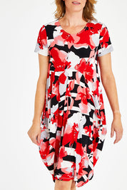Model Naomi wearing size 10 of the Cap Sleeve Bounce Dress in colour Red (Red), from the front, cropped image