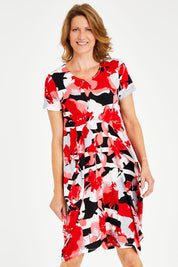 Model Naomi wearing size 10 of the Cap Sleeve Bounce Dress in colour Red (Red), from the front, cropped image