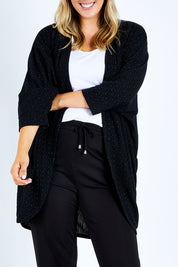Model Jess wearing size 14 of the Cocoon Cardy in colour Black (Black), from the front, cropped image