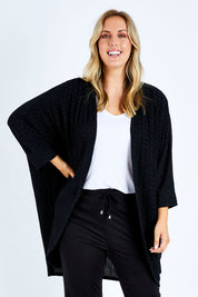 Model Jess wearing size 14 of the Cocoon Cardy in colour Black (Black), from the front, cropped image