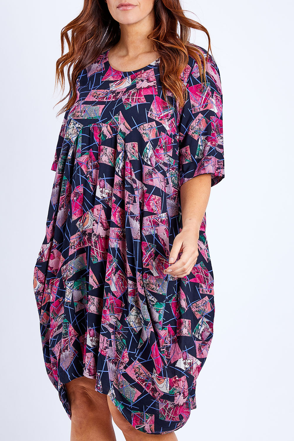 Model Laura wearing size 14 of the Rayon Bounce Dress in colour Print (Pink), from the front, cropped image