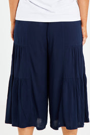 Model Jess wearing size 14 of the Gaucho Pant in colour Navy (Blue), from the back