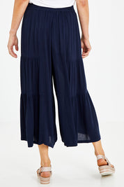 Model Naomi wearing size 10 of the Gaucho Pant in colour Navy (Blue), from the back