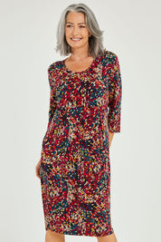Model Luisa wearing size 10 of the Box Pleat Dress in colour Multiprint (Black), from the front, cropped image