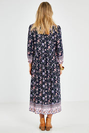 Model Kelly wearing size 10 of the Boheme Long Sleeve Print Dress in colour Navy (Blue), from the back