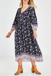 Model Kelly wearing size 10 of the Boheme Long Sleeve Print Dress in colour Navy (Blue), from the front, cropped image