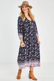 Model Kelly wearing size 10 of the Boheme Long Sleeve Print Dress in colour Navy (Blue), from the front, showing the whole outfit