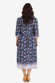 Model Laura wearing size 14 of the Boheme Long Sleeve Print Dress in colour Navy (Blue), from the back
