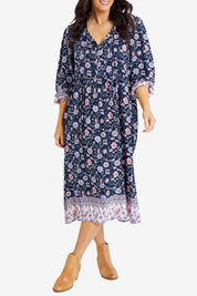 Model Laura wearing size 14 of the Boheme Long Sleeve Print Dress in colour Navy (Blue), from the front, cropped image