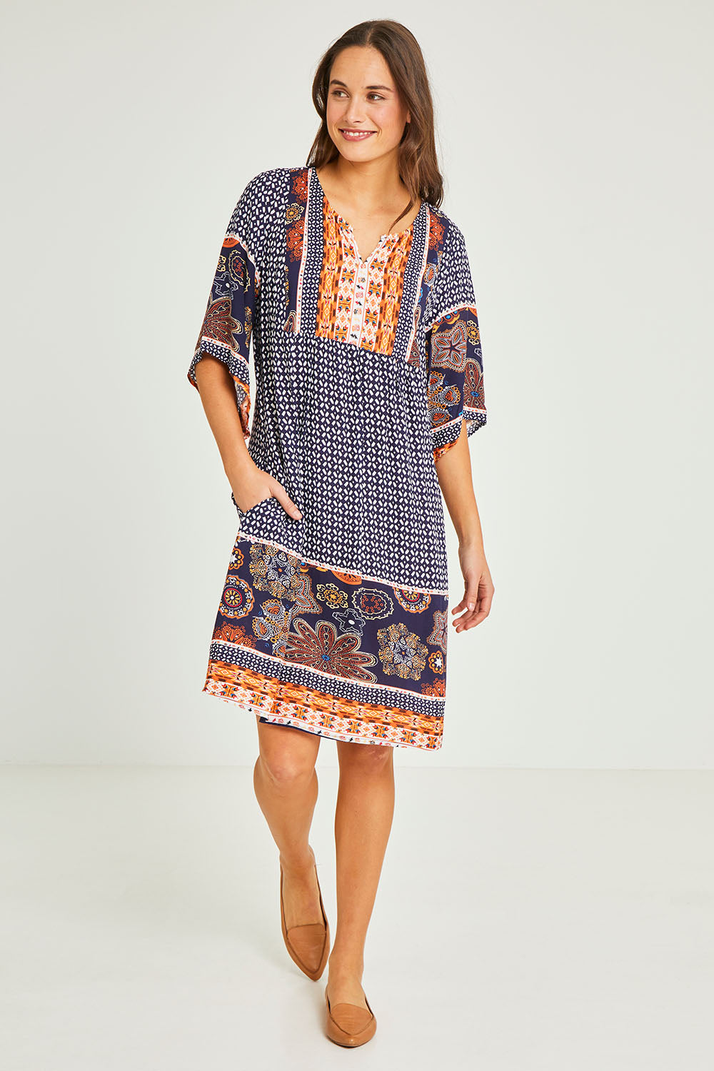 Model Elhana wearing size 10 of the Sun Dress in colour Navyprint (Blue), from the front, showing the whole outfit