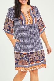 Model Terri-Leigh wearing size 14 of the Sun Dress in colour Navyprint (Blue), from the front, cropped image