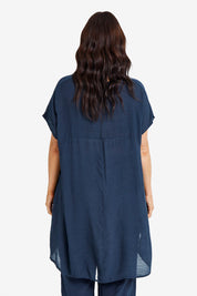 Model Laura wearing size M-L of the Snow Drop Hi Low Top in colour Slate (Grey), from the back