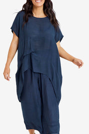 Model Laura wearing size M-L of the Snow Drop Hi Low Top in colour Slate (Grey), from the front, cropped image