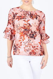 Model Lisa wearing size 10 of the Frill Sleeve Top in colour LeafPrint (Pink), from the front, cropped image