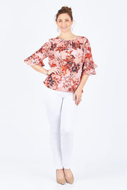 Model Lisa wearing size 10 of the Frill Sleeve Top in colour LeafPrint (Pink), from the front, showing the whole outfit