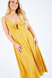 Model Hayley wearing size S of the Zuma Maxi in colour Saffron, from the front, cropped image