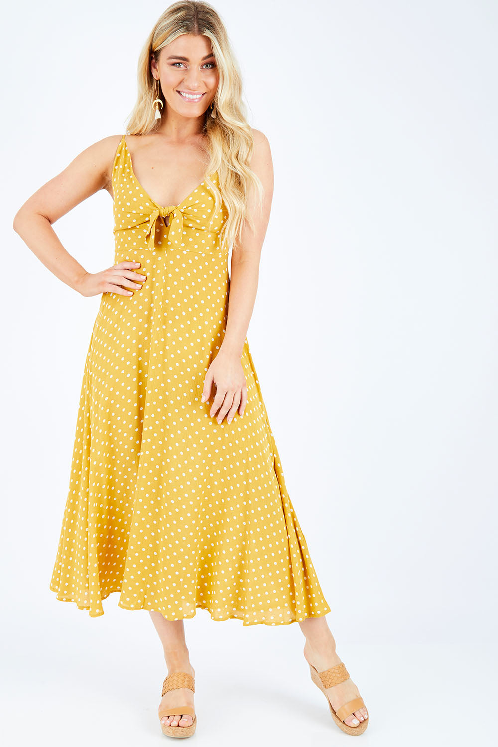 Model Hayley wearing size S of the Zuma Maxi in colour Saffron, from the front, showing the whole outfit