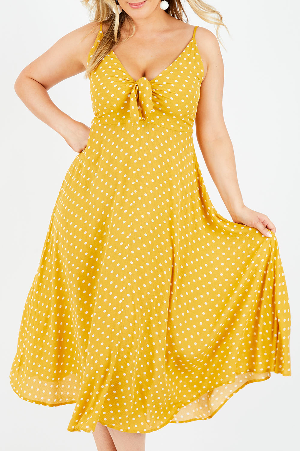 Model Jess wearing size L of the Zuma Maxi in colour Saffron, from the front, cropped image
