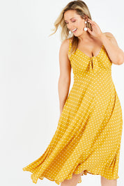 Model Jess wearing size L of the Zuma Maxi in colour Saffron, from the front, cropped image