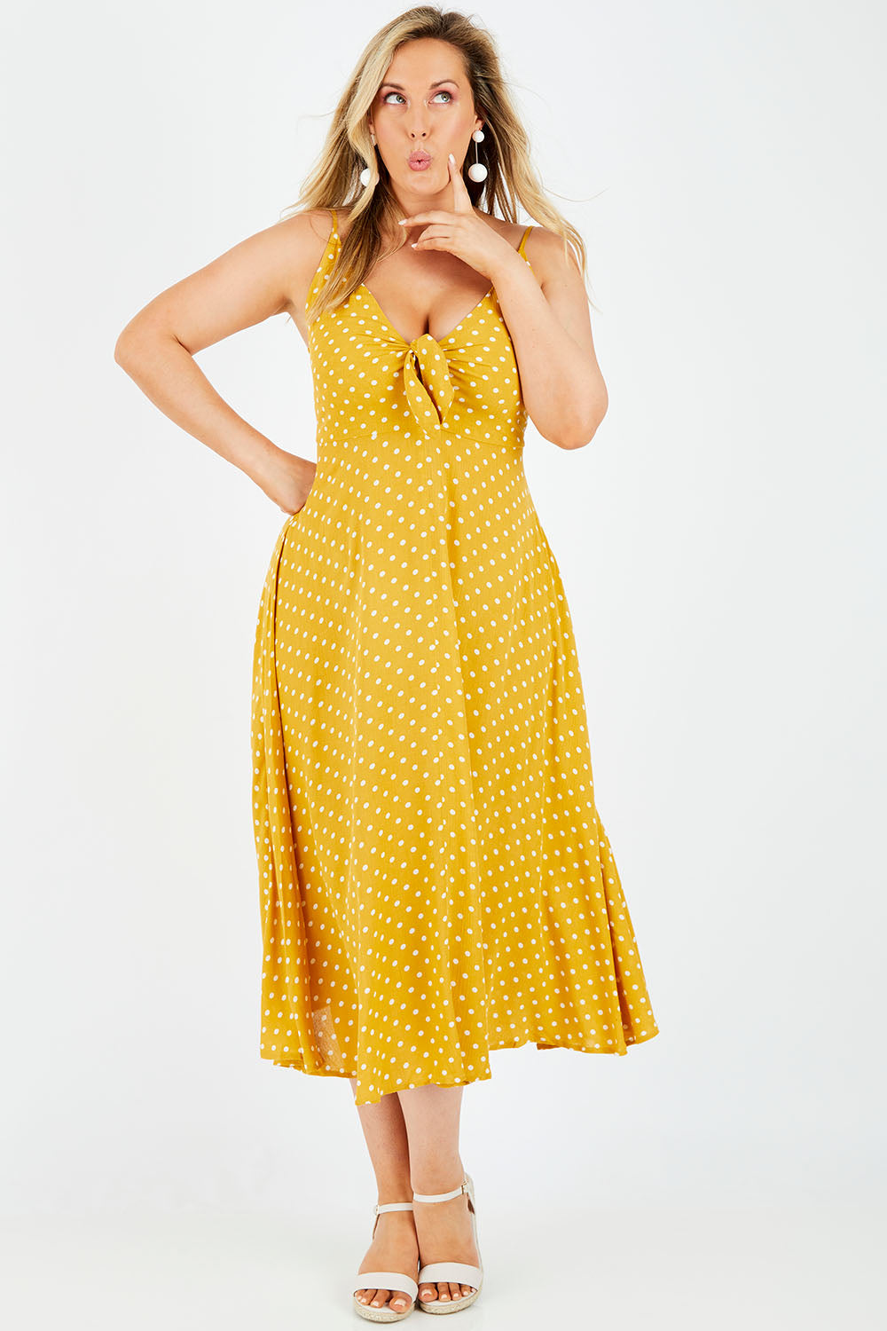 Model Jess wearing size L of the Zuma Maxi in colour Saffron, from the front, showing the whole outfit
