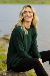 Model Alice wearing size OneSize of the Poppy Knit in colour Forest (Green), from the front, showing the whole outfit