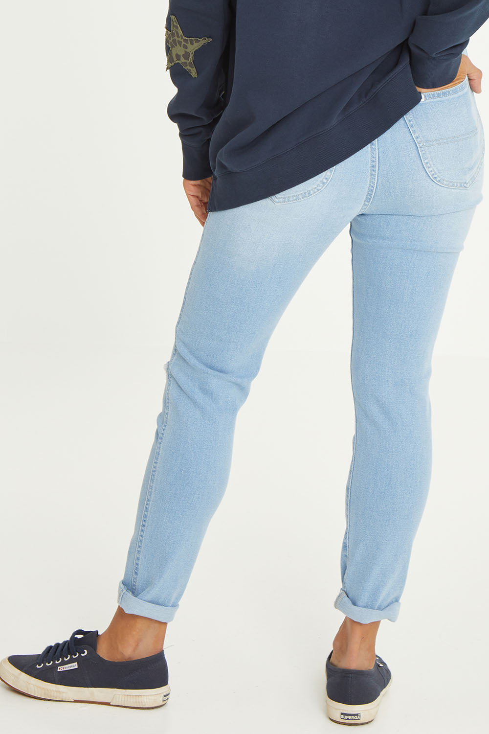 Model Cara wearing size 10 of the Hi Rider in colour Astral (Blue), from the back