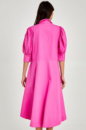 Model Madeline wearing size 10 of the Primrose Dress in colour Superpink (Pink), from the back