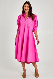 Model Madeline wearing size 10 of the Primrose Dress in colour Superpink (Pink), from the front, showing the whole outfit