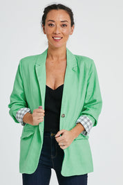 Model Katie wearing size 10 of the Millie Blazer in colour Blimegree (Green), from the front, cropped image