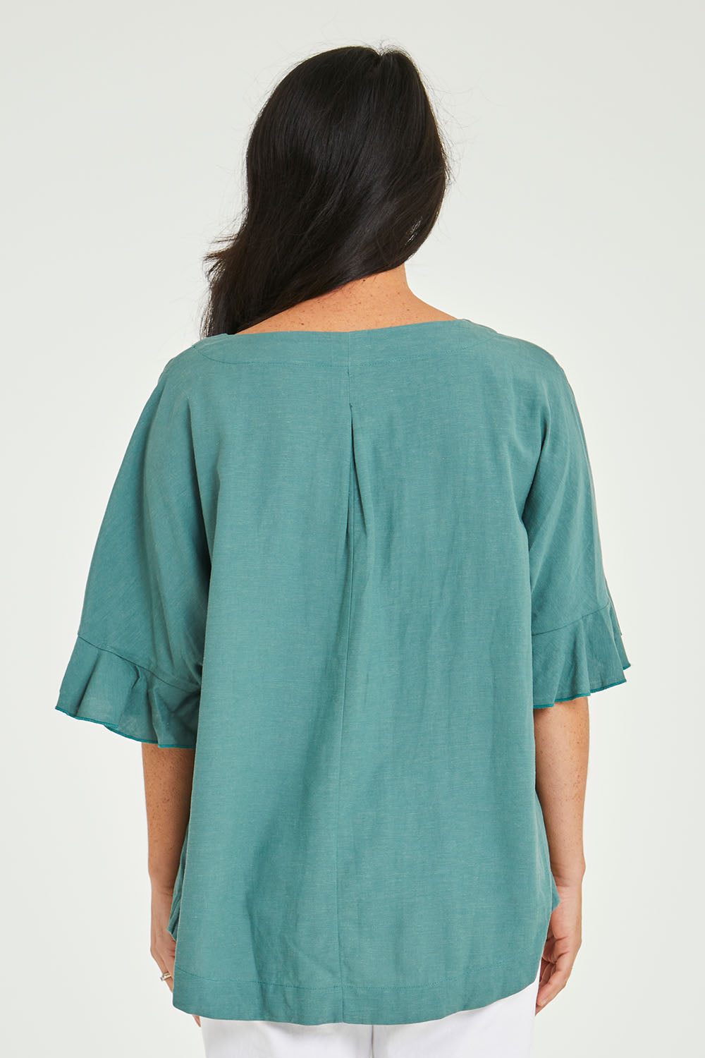 Model Katie wearing size 10 of the Miranda Top in colour Rosemary (Green), from the back