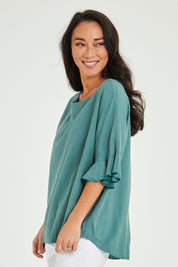 Model Katie wearing size 10 of the Miranda Top in colour Rosemary (Green), from the front, cropped image