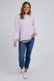 A model wearing the Piper Sweat in colour Lilac (Purple), from the front, showing the whole outfit