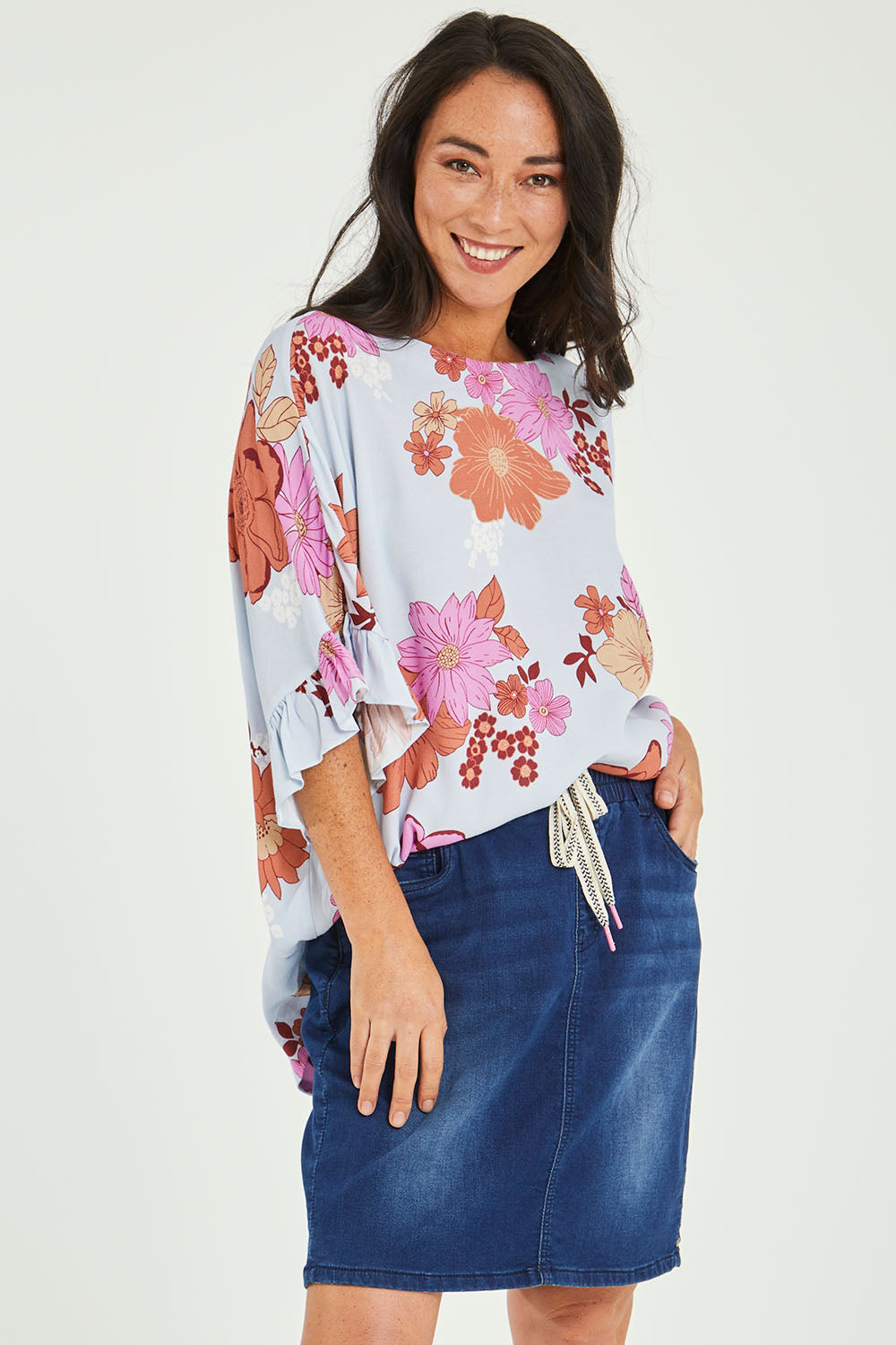 Model Katie wearing size 10 of the Status Denim Skirt in colour Darkblue (Blue), from the front, cropped image