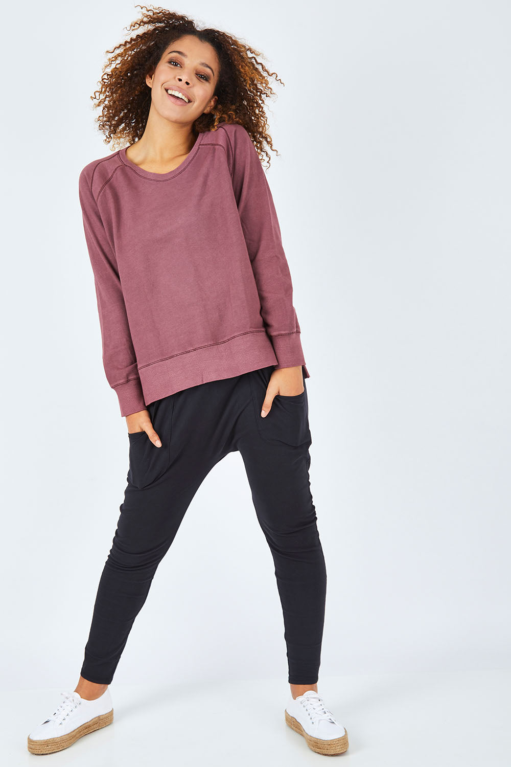 Model Summer wearing size 10 of the Fundamental Weekend Pant in colour Black (Black), from the front, showing the whole outfit