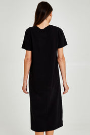 Model Madeline wearing size 10 of the Fundamental Adira Dress in colour Black (Black), from the back