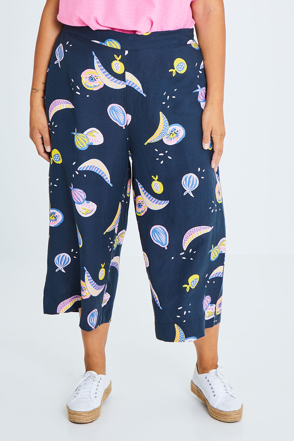 Model Palatina wearing size 10 of the Fruity Tootie Pant in colour Navymulti (Blue), from the front, cropped image