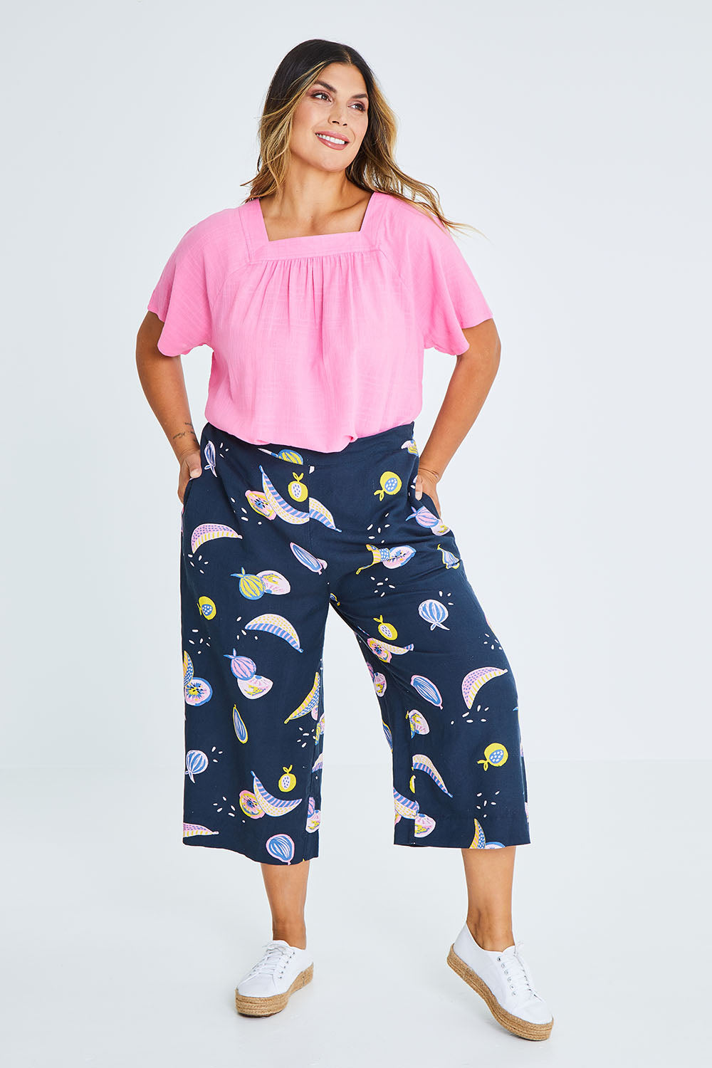 Model Palatina wearing size 16 of the Fruity Tootie Pant in colour Navymulti (Blue), from the front, showing the whole outfit