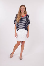 A model wearing the Stretch Denim Skirt in colour White (White), from the front, showing the whole outfit