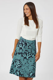 Model Cara wearing size S of the Avril Skirt Long Mikko in colour Greenink (Blue), from the front, cropped image