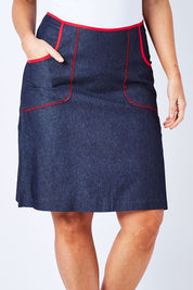 Model Laura wearing size M of the Denim Pocket Skirt in colour Denim (Blue), from the front, cropped image
