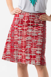 A model wearing the Sticks A line Skirt in colour RedGrey (Red), from the front, cropped image