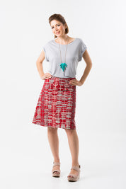 A model wearing the Sticks A line Skirt in colour RedGrey (Red), from the front, showing the whole outfit