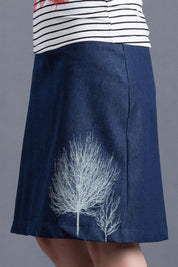A model wearing the 2 Trees Panel Skirt in colour NatIndigo (Blue), from the front, cropped image