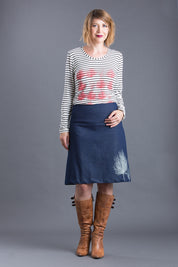 A model wearing the 2 Trees Panel Skirt in colour NatIndigo (Blue), from the front, showing the whole outfit