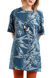 A model wearing the Lark French Tunic in colour BlueSilver (Blue), from the front, cropped image