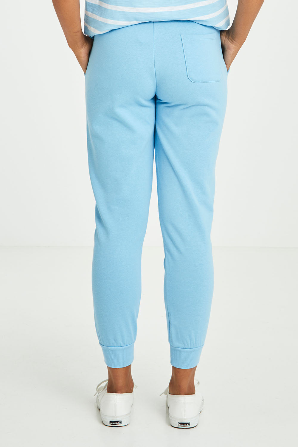 Model Olivia wearing size 10 of the Greta Jogger in colour Iceblue (Blue), from the back