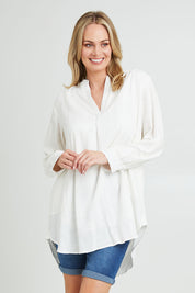 Model Grace wearing size 10 of the Beach Tunic Shirt in colour White (White), from the front, cropped image