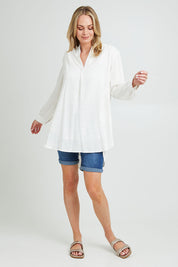 Model Grace wearing size 10 of the Beach Tunic Shirt in colour White (White), from the front, showing the whole outfit