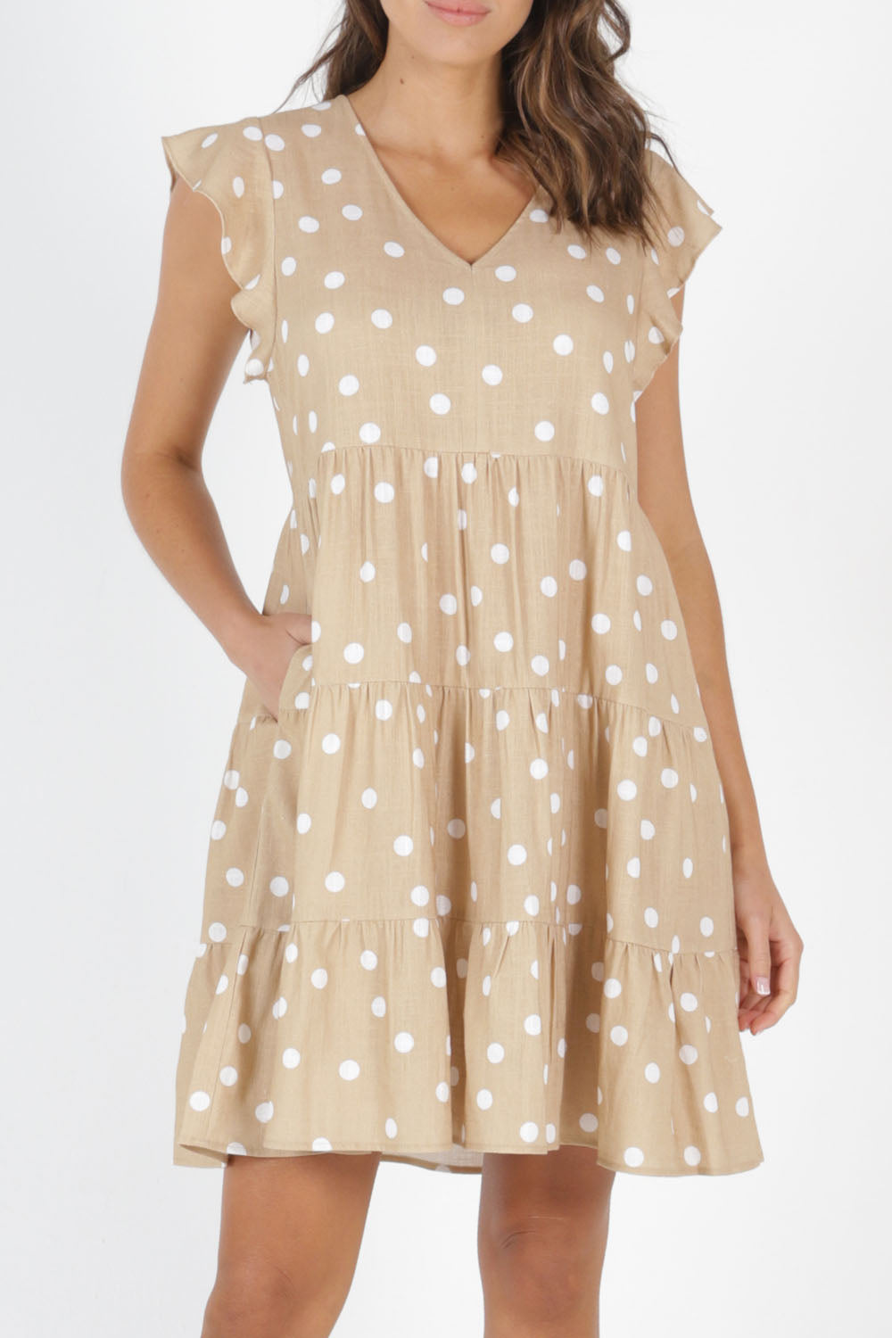Model Madeline wearing size 10 of the Skyler Dress in colour Ecruspot, from the front, cropped image